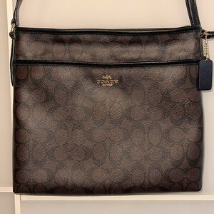 Coach brand new. Never used. Crossbody bag. Light brown with darker brown C’s.